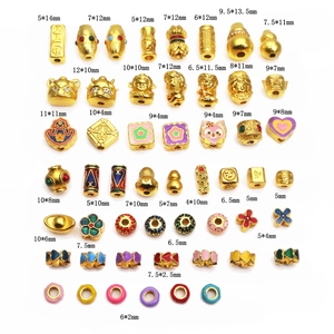 Detailed view of gold-plated copper beads with enamel and crystal accents for jewelry making