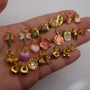 Golden enamel charms collection featuring dragonfly and flower designs for DIY jewelry