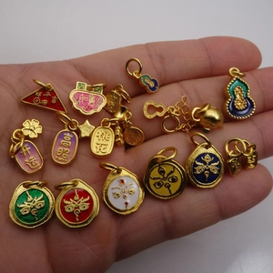 Gold-plated enamel charms for DIY jewelry featuring traditional folk patterns on palm