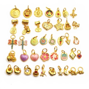 Collection of gold enamel charms featuring religious figures and traditional lucky symbols