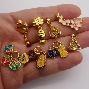 Collection de breloques en émail doré avec symboles traditionnels de koi et de fortune