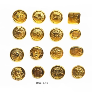 Detailed view of gold-plated lucky charms and Fortune beads featuring Chinese characters