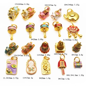Detail of assorted gold enamel charms including animals and traditional lucky elements