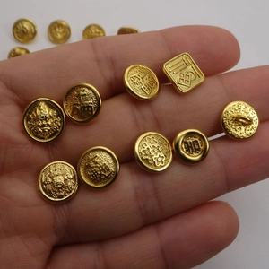 Matte gold sand gold charms featuring lucky Chinese characters held in hand