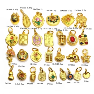Close-up of assorted gold-plated Chinese charms with traditional symbols and patterns