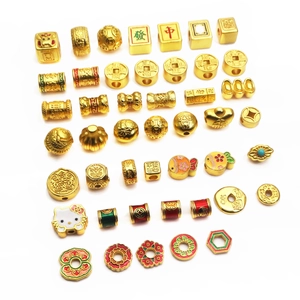 Gold-plated brass lucky charms and beads collection with traditional symbols and icons