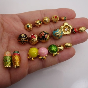Mano con cuentas doradas DIY que incluyen flores de esmalte y dijes de tortugas de colores