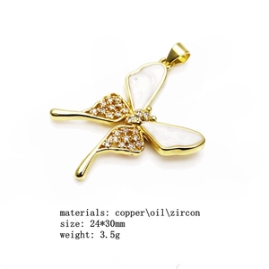 Macro detail of copper butterfly pendant with zircons and drip oil inlay 24x30mm