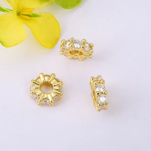 Macro shot of gold-plated 4mm and 8mm wheel spacers with micro-pave cubic zirconia crystals