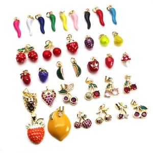 Colorful enamel fruit pendants including strawberry, cherry, and chili for DIY jewelry