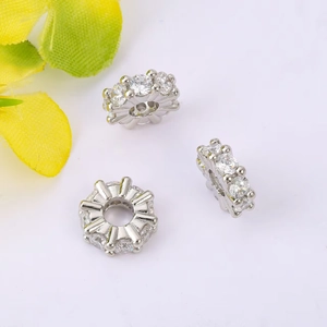 Macro shot of silver micro-pave cubic zirconia wheel spacer beads for jewelry making