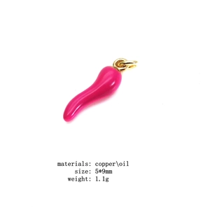 Macro shot of 5x9mm magenta chili pepper pendant with gold plating and enamel finish