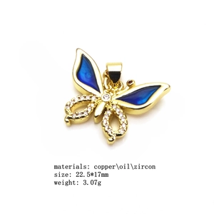Detail of blue enamel butterfly pendant with cubic zirconia and gold plating