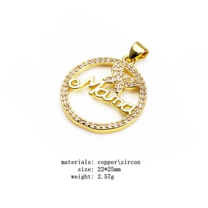 Macro detail of gold plated Mama pendant featuring a crystal butterfly and zircon stones
