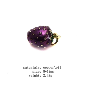 Detail of purple oil-drop strawberry charm in copper with green leaf and golden specs