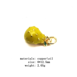 Macro view of 8x12.5mm yellow pear fruit charm with green leaf and gold copper loop