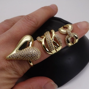 Three-piece gold adjustable ring set with heart, twisted, and infinity micro-pave zircon designs