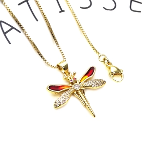 Gold dragonfly necklace with enamel wings and cubic zirconia on a square box chain