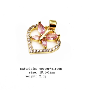 Macro detail of heart-shaped zircon pendant with pink butterfly stones and dimensions
