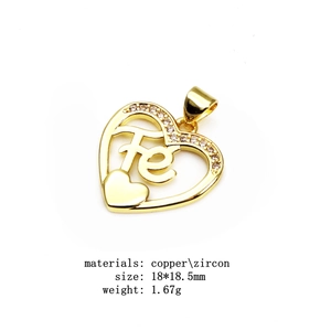 Macro detail of gold-plated copper heart pendant with Fe letter and white zircon inlay