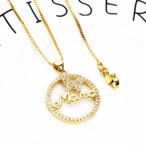 Close-up of gold-plated Mama circle pendant with butterfly and pavé set zircons