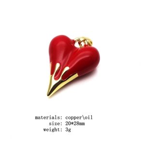 Red enamel heart pendant with golden drip design on a minimalist copper box chain