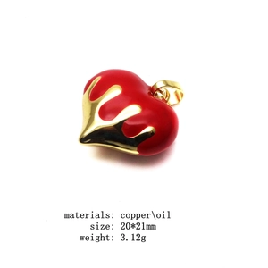 Close-up of heart-shaped copper pendant with red oil finish and gold-plated fluid lines