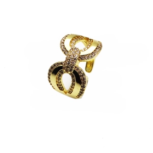 Macro detail of gold plated ring with micro-set white cubic zirconia and infinity knot design