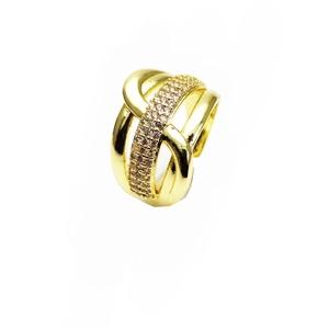 Detailed view of multi-layer cross ring with gold plating and pavé cubic zirconia