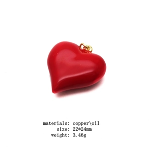 Detail of red enamel heart pendant with dimensions 22x24mm and 18k gold plated copper finish