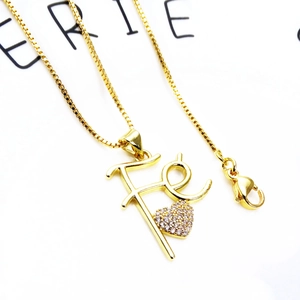 Detail of gold-plated box chain with micro-pave zircon heart and Fé letter pendant