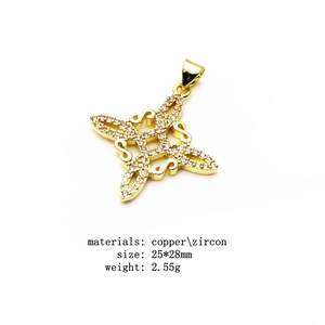 Macro view of gold plated copper Celtic knot pendant with sparkling cubic zirconia stones