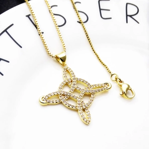 Macro detail of gold Celtic knot pendant with micro-paved zircons on a sturdy box chain
