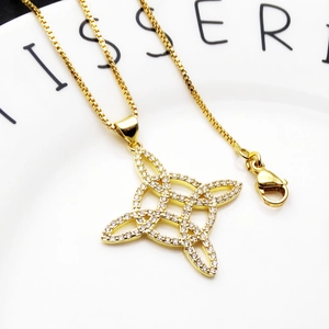 Close-up of gold plated Celtic knot pendant with cubic zirconia on a box chain