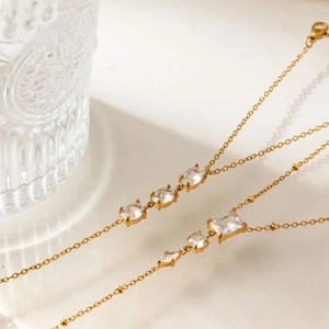 Gedetailleerd overzicht van gouden vingerarmbanden met heldere zirkoniasteentjes voor