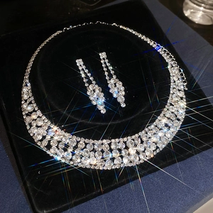 Luxurious sparkling rhinestone necklace and earrings jewelry set on black velvet