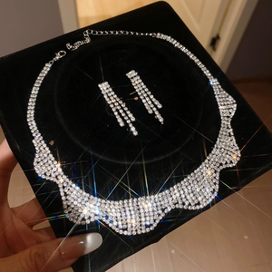 Sparkling rhinestone tassel necklace and earrings jewelry set on black velvet