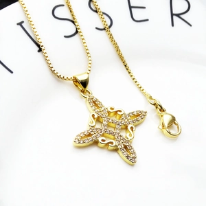Close-up of golden Celtic knot pendant with sparkling cubic zirconia on box chain