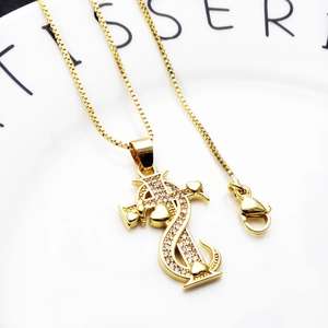 Detailed view of gold dollar sign cross pendant with micro-pave cubic zirconia on box chain