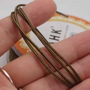 Macro detail of 1.4mm two-tone braided cord showing spiral weave texture on fingertips