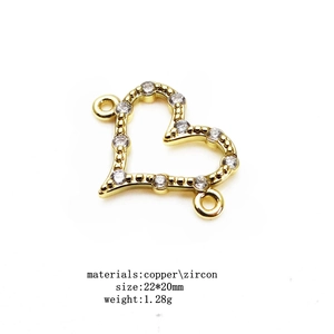 Macro view of gold copper heart connector with pavé zircon stones for DIY jewelry making