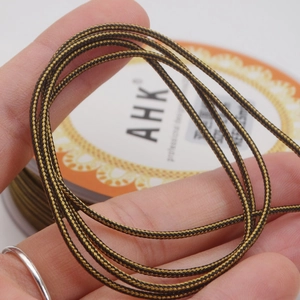 Close-up of 1.4mm black and gold braided cord showing dense spiral texture for jewelry DIY