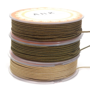 Detailed macro of 1.4mm two-tone braided cords on spools for DIY jewelry making