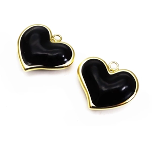 Close-up of black enamel heart charms with gold edges for DIY necklace jewelry making