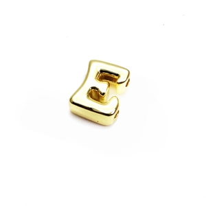 Detailed macro of a 14K gold-plated letter E bead charm for DIY jewelry making