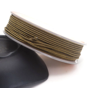 Detail of 1.4mm black and gold braided cord roll for DIY jewelry and necklaces