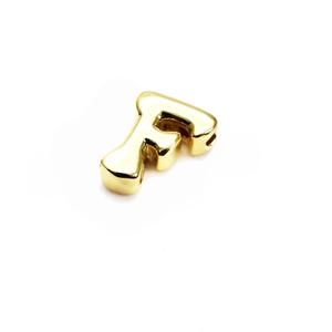 Macro view of polished 14K gold-plated letter F bead charm with side through hole