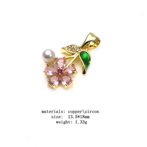 Zircon flower petal pendant necklace with pearl and green leaf detail in gold plated copper