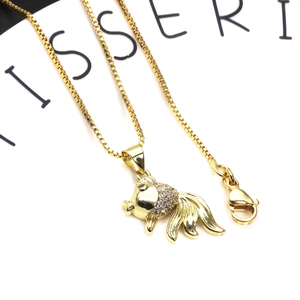 Macro view of gold-plated goldfish pendant with micro-pave cubic zirconia on box chain