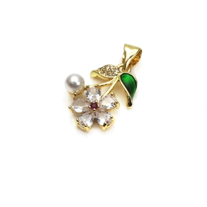 Detail of flower pendant with micro-set zircons, red center stone, pearl and green leaf